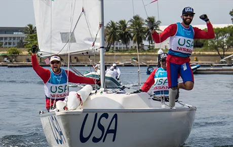 Parasailing athletes navigate their boat.