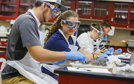 Students work on an experiment inside the chemistry lab.