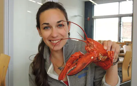 Student holds up a boiled lobster
