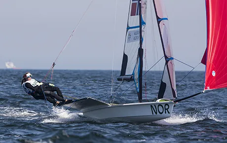 Olympic sailing athlete navigates her boat.