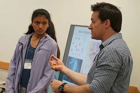 Professor instructing a classroom.