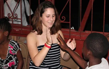 Student plays with a young child