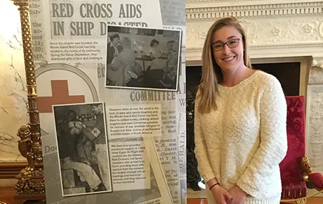Students stands with exhibit panel