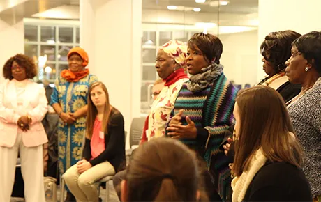Women from a local refugee group talk to students about their experiences.