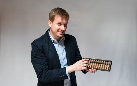 Professor Robert Jacobson with an abacus.