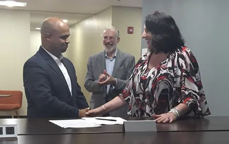 Two people shake hands in recognition of forming a new partnership.