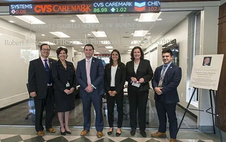 Students, faculty and donors celebrate the opening of a renovated financial trading room.