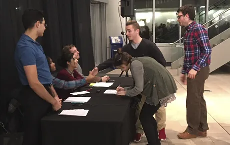 Students gather to talk and sign an agreement to continue civil discourse.