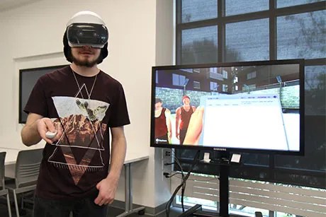 Student using virtual reality to take a science lab.