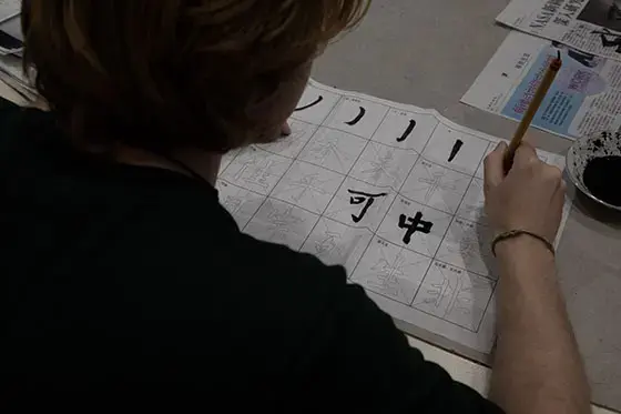 A student practices Chinese calligraphy