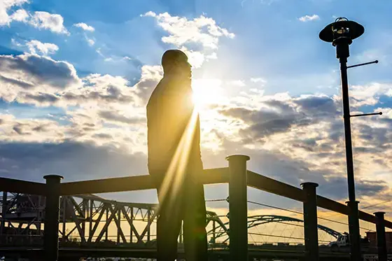 Silhouette of Meko Lincoln against a cloudy sky