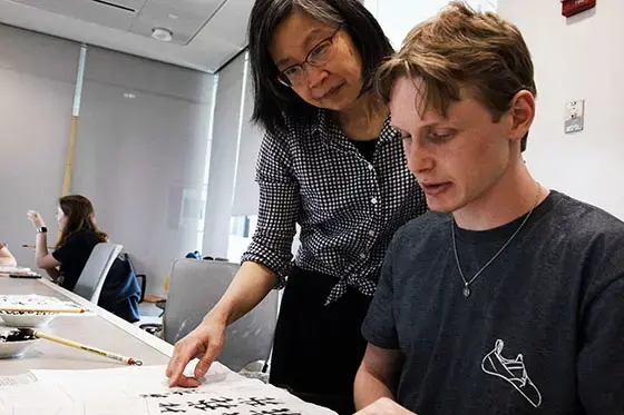 A professor teaches Chinese calligraphy