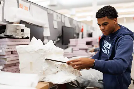 A student works in the studio on a project