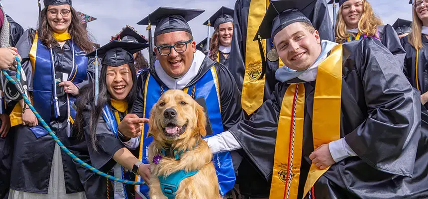 A group of smiling graduates at commencement