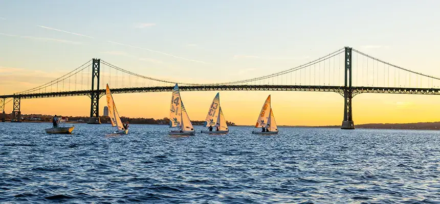 RWU sailboats in front of Mount Hope Bridge