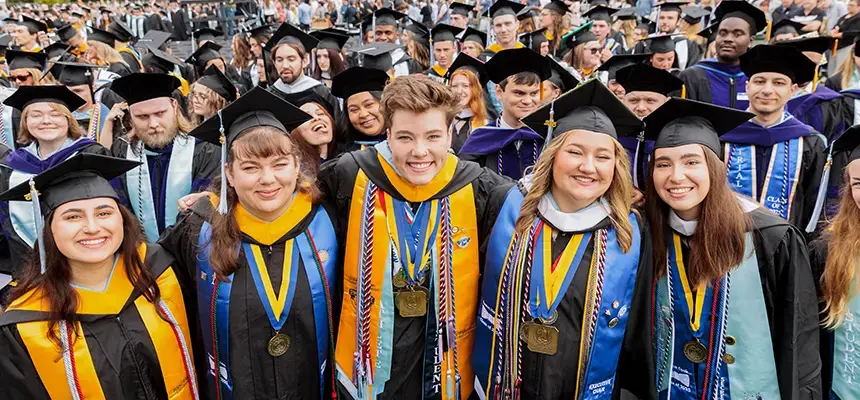 Crowd of smiling students at commencement