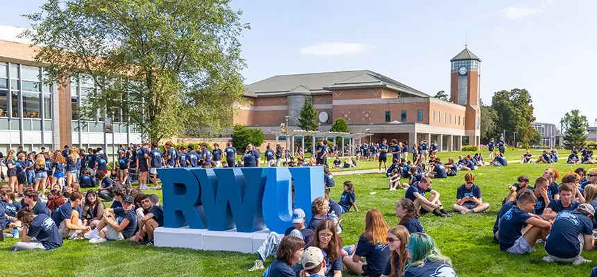 Students sit in groups talking at Convocation