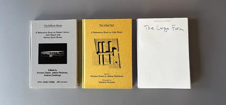 Three books laid out on a desk