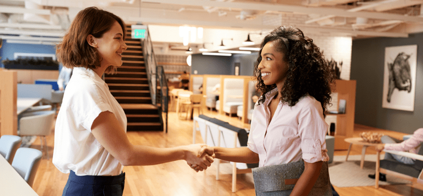 Women business students shake hands