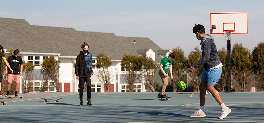 Students play sports and skateboard on campus