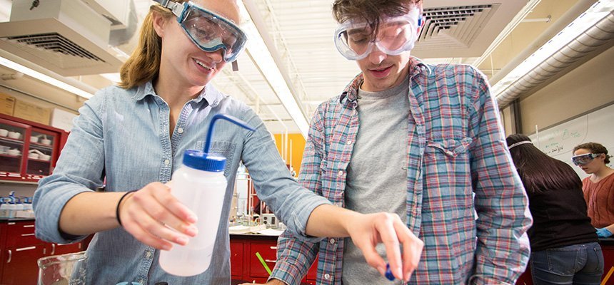 Two students collaborate in a lab setting