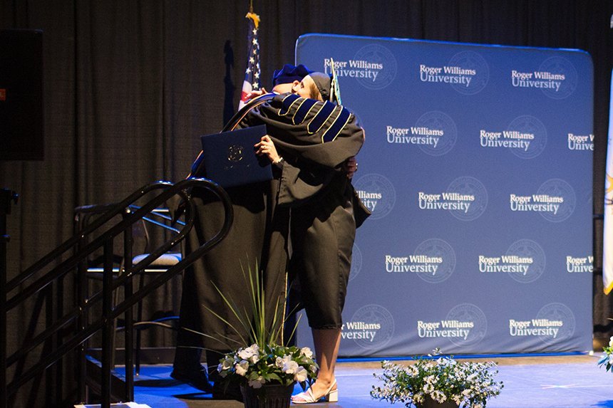 A 2020 graduate hugs their Dean