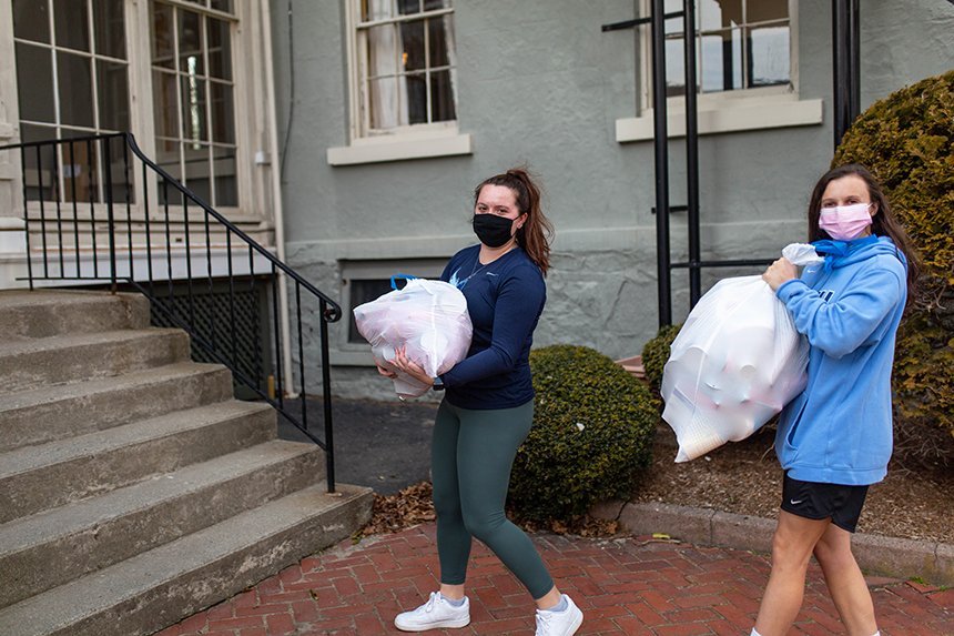image of RWU Field Hockey's Community Outreach group’s Brooklyn Cenatiempo delivers donations to the Women’s Resource Center in Warren, RI, during Women’s History Month. 