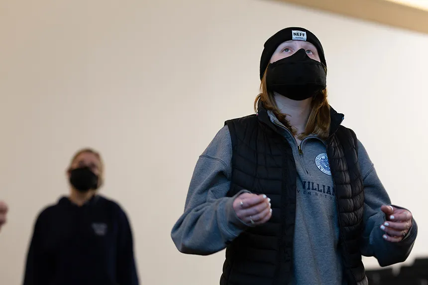 Image of a member of Hawkward a capella singing group at practice wearing a mask made especially for singing