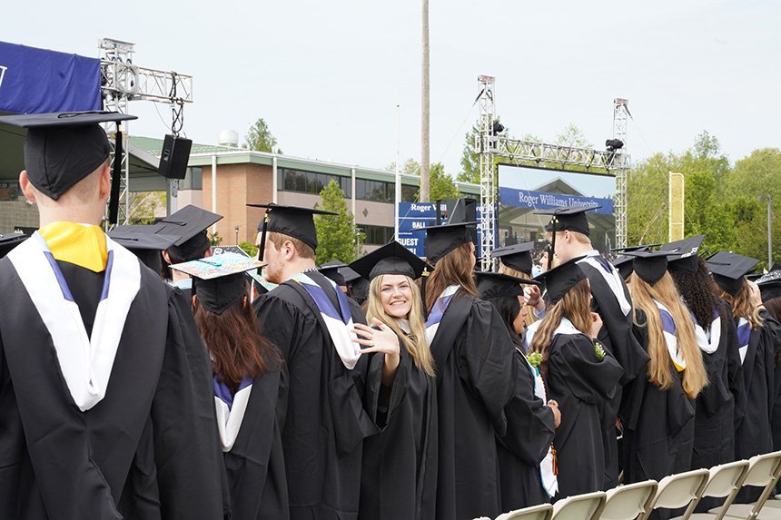 Graduate smiles from within crowd 