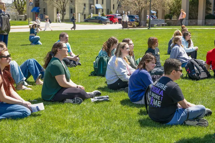 Students sitting on the grass.