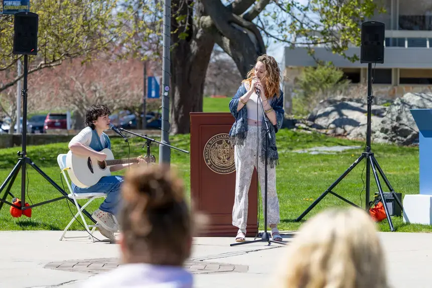 Two students performing in front of an audience.
