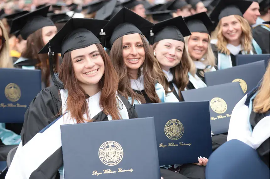Graduates show off their diplomas.