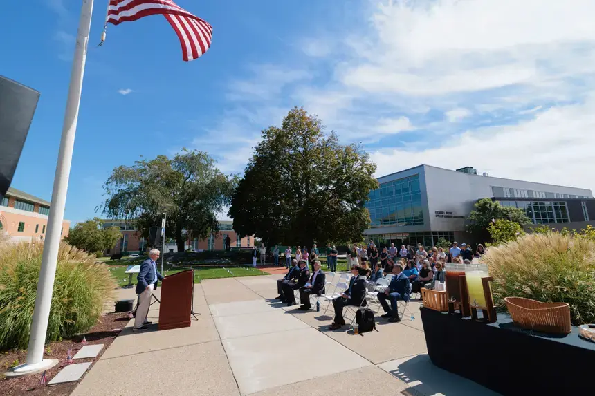 Attendees listen to speakers outside the Administration Building.