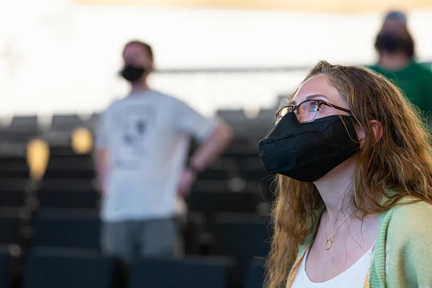 Image of a member of Hawkward a capella singing group at practice wearing a mask made especially for singing