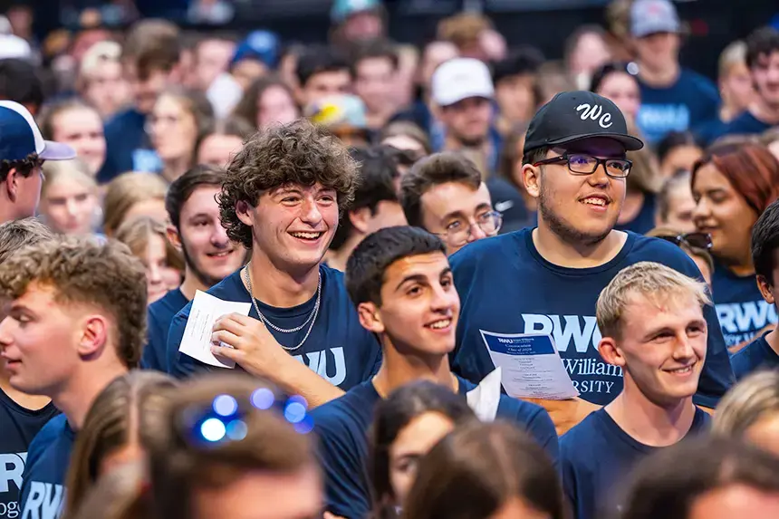 New undergraduate students laugh along with remarks.