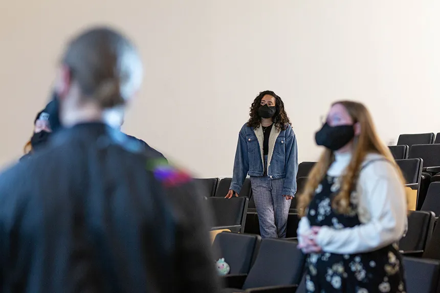 Image of members of Hawkward a capella singing group at practice wearing a mask made especially for singing