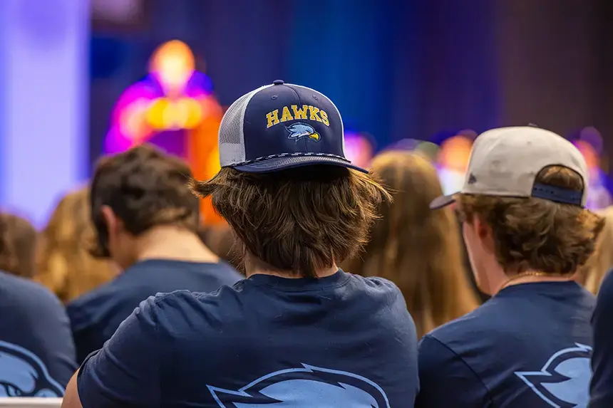 A new student sports a RWU Hawk hat at Convocation.