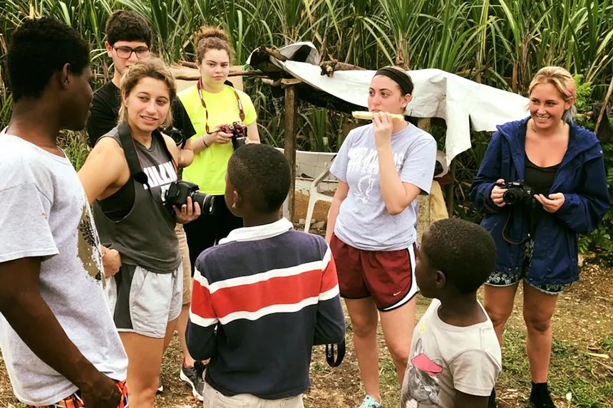 RWU students stand by a field with students