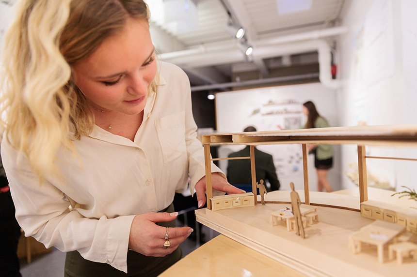 An Architecture student looks at a 3D model of her design of a kindergarten classroom