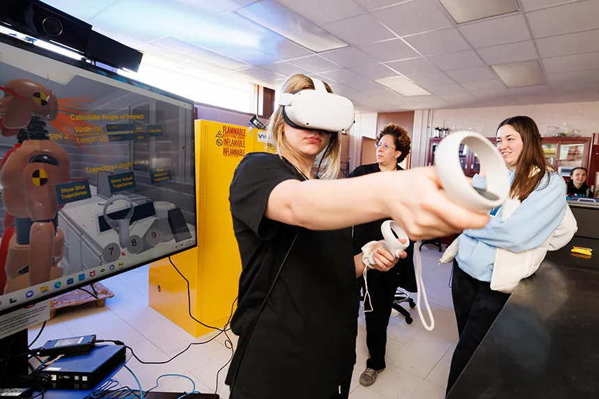 A student uses a VR program to calculate blood spatter as part of a crime scene class.