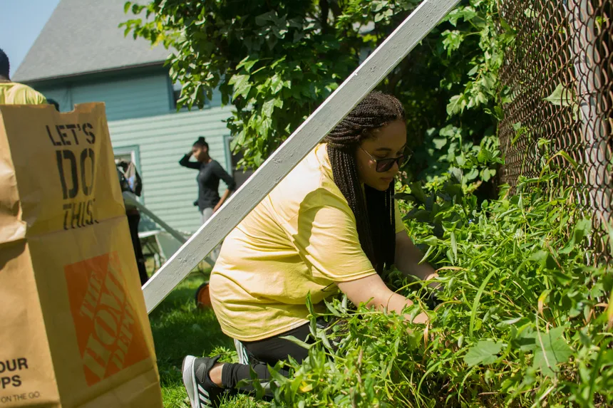Student pulling weeds
