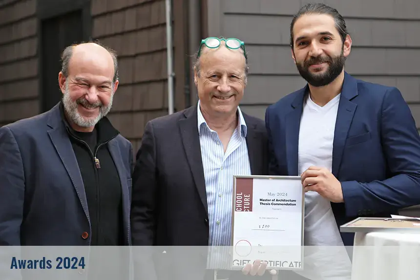 Student posing with their award and professors