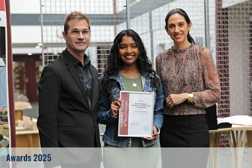 Student posing with their award and professors