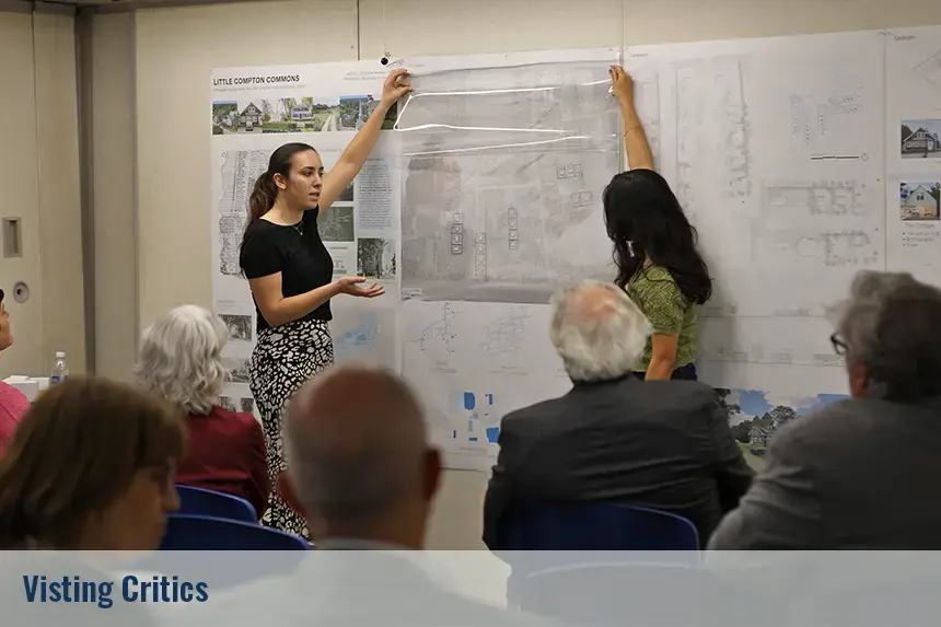 Students presenting their project posted on the walls