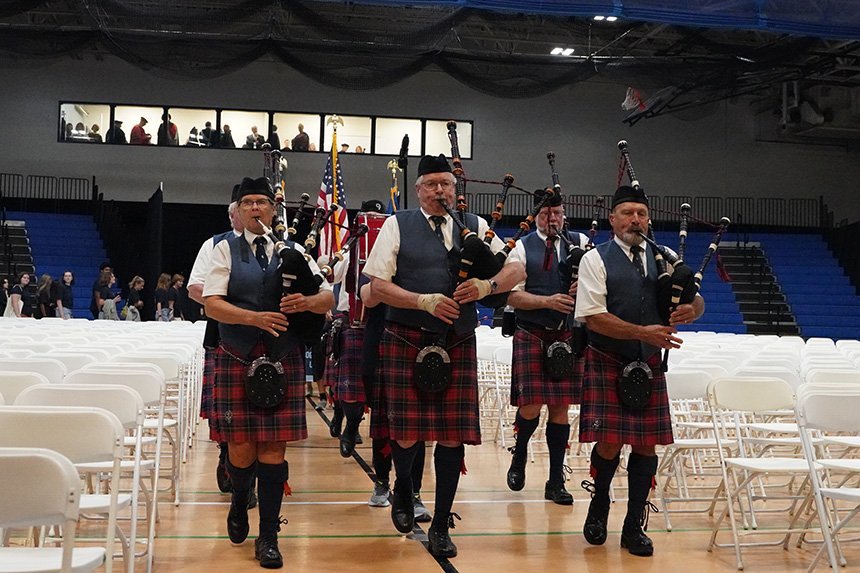 Bagpipers playing and walking through the fieldhouse at RWU 