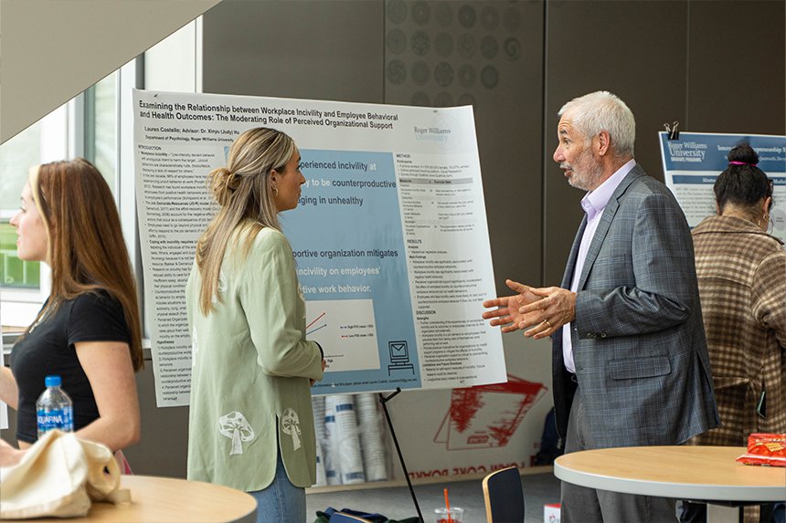A student talking with a dean in GHH 