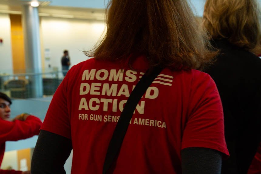Back of shirt says "Moms Demand Action."