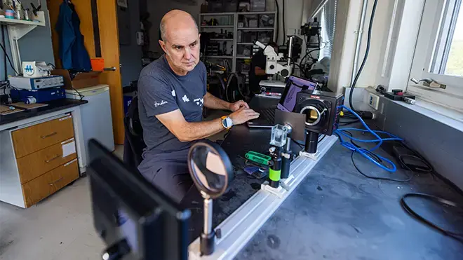 Professor Colin looks over data at his desk.