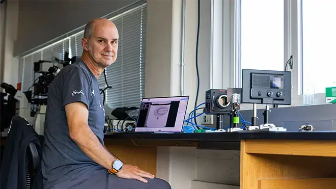 Sean Colin sits at his desk at his Cape Cod lab.
