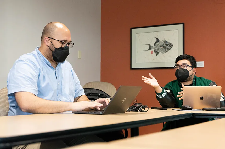 Jerrel Burgo, MSU's advisor, and president Jesahias Quiroa talk during an e-board meeting.